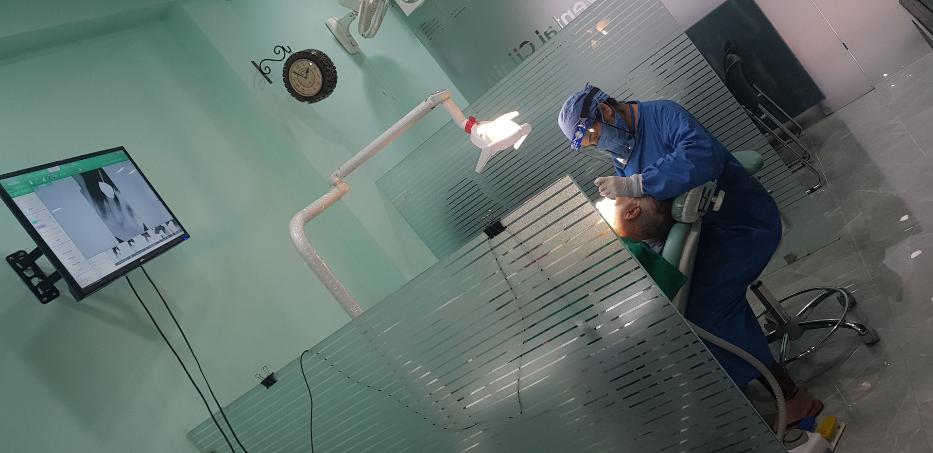 Dentist performing a procedure at Arjan Dental Clinic